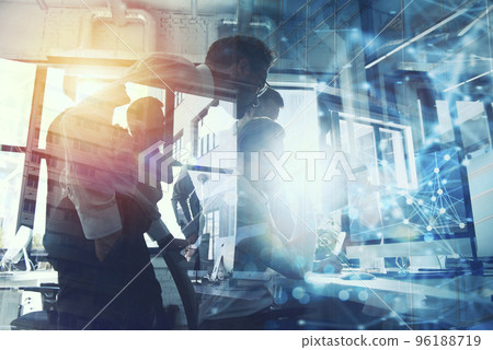 Teamwork works with a computer. Concept of internet sharing and interconnection. double exposure. 96188719