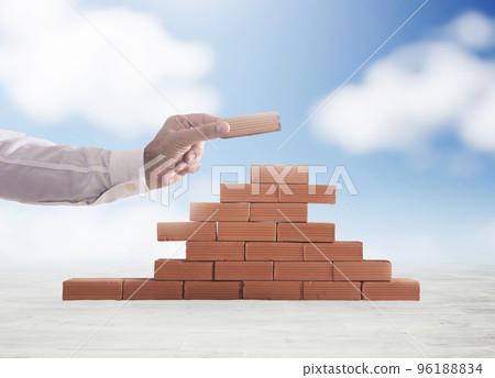 Businessman puts a brick to build a wall. Concept of new business, partnership, integration and startup 96188834
