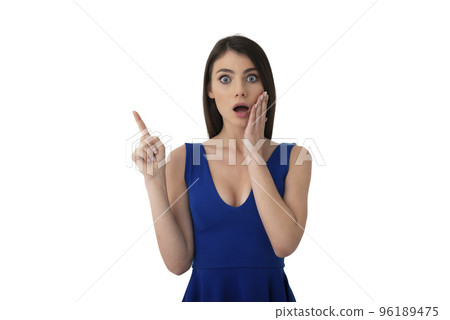 Surprised girl indicates a blank space for your text. Isolated on white background 96189475