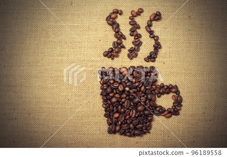 Coffee beans shaped as cup over a jute cloth Coffee beans shaped as cup over a jute cloth 96189558