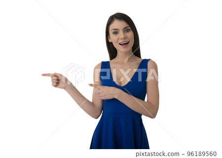 Surprised girl indicates a blank space for your text. Isolated on white background 96189560