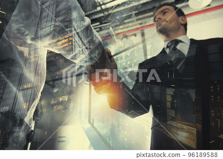 Handshaking business person in the office with network effect. concept of teamwork and partnership. double exposure Handshaking business person in the office with network effect. concept of teamwork and partnership. double exposure 96189588