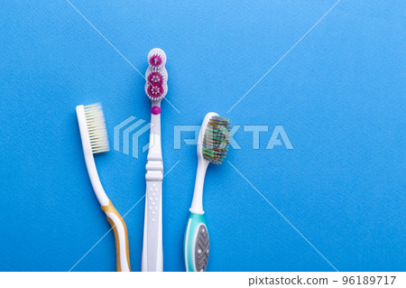 Toothbrushes on blue background. Space for text. Top view. 96189717