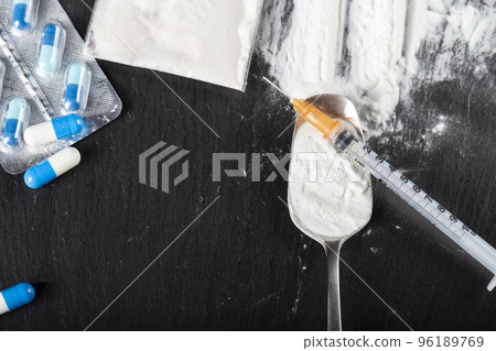 Substance abuse. Hard drugs on dark table 96189769