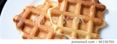 Fresh delicious homemade waffles on white plate 96190760