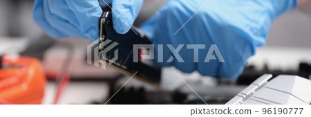 Technician connects CPU microprocessor to motherboard socket Technician connects CPU microprocessor to motherboard socket 96190777