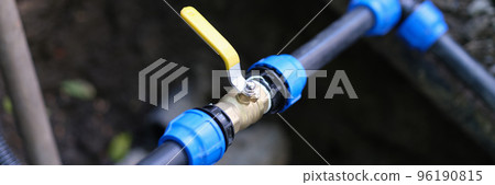 Water valve connected to PVC pipe closeup Water valve connected to PVC pipe closeup 96190815