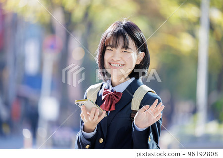 School girls waving hands 96192808
