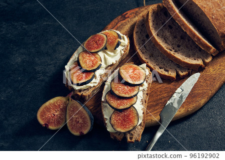 slices of rye bread with figs and pomegranate slices of rye bread with figs and pomegranate 96192902