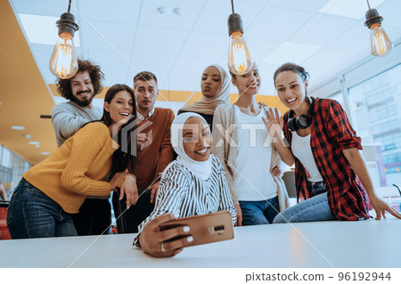 Business people team group taking selfie photo on mobile phone at modern open space office coworking space Business people team group taking selfie photo on mobile phone at modern open space office coworking space 96192944