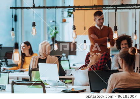 Multiethnic group of employees working in a marketing company. A group of colleagues is working on a project in modern offices Multiethnic group of employees working in a marketing company. A group of colleagues is working on a project in modern offices 96193007