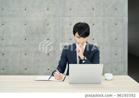 man working at a computer man working at a computer 96193592