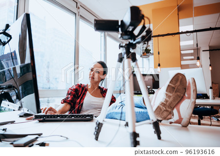 A young woman using a camera to present her business with online clients A young woman using a camera to present her business with online clients 96193616