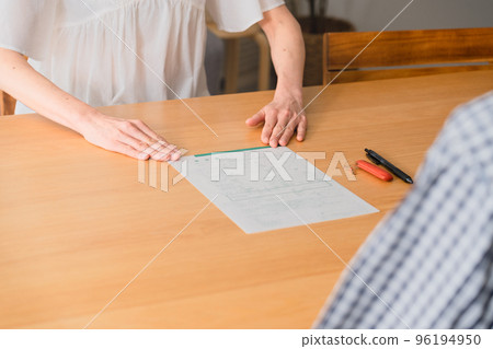 A middle-aged woman presenting a divorce notice to a middle-aged man Image of a middle-aged divorce 96194950
