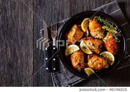 roast chicken thighs with lemon, thyme and spices 96196028