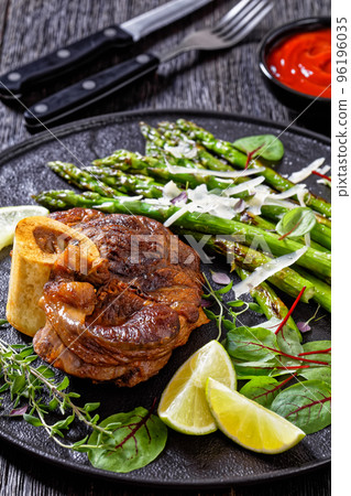 braised osso buco with grilled asparagus, top view braised osso buco with grilled asparagus, top view 96196035