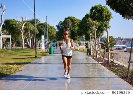Woman jogging near beach 4k. Caucasian woman jogging in the morning near the beach in Turkey Woman jogging near beach 4k. Caucasian woman jogging in the morning near the beach in Turkey 96196259