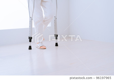 Middle-aged woman walking with crutches Rehabilitation image 96197965