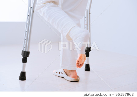 Middle-aged woman walking with crutches Rehabilitation image 96197968