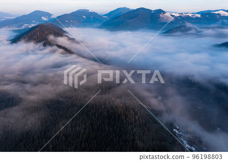 Carpathian peaks in the morning in the clouds, top view, drone footage. Carpathian peaks in the morning in the clouds, top view, drone footage. 96198803