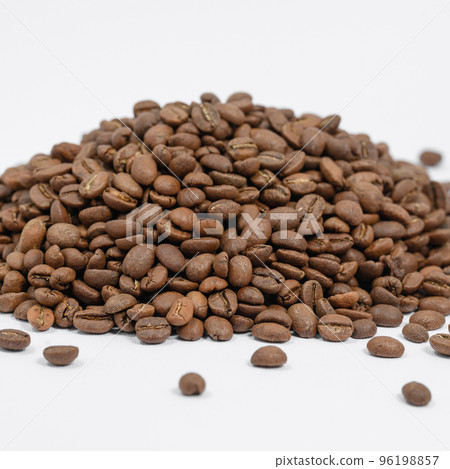 A pile of coffee beans on a white background, place for advertising. A pile of coffee beans on a white background, place for advertising. 96198857