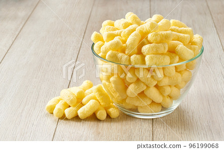 Corn sticks in a  glass plate on a white wooden table, selective focus. 96199068