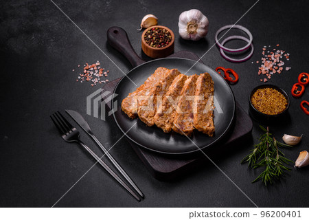 Tasty meat brawn or roll on a wooden cutting board with spices and herbs Tasty meat brawn or roll on a wooden cutting board with spices and herbs 96200401