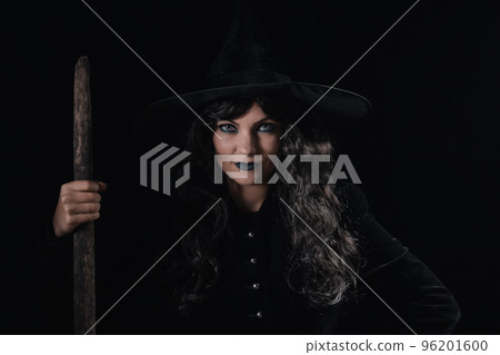 Portrait of black witch at night. Halloween masquerade costume, party decoration. Magic, classic hag 96201600