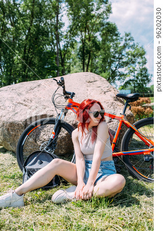 Young attractive woman is resting after bicycle ride. Active lifestyle, sports Young attractive woman is resting after bicycle ride. Active lifestyle, sports 96202030