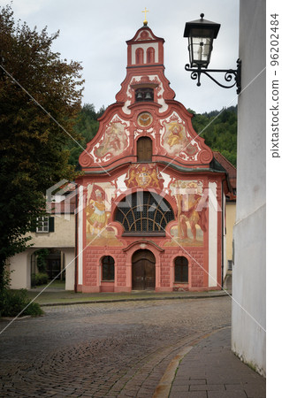 View of the traditional painted bavarian church of the holy spirit in the village of Fussen View of the traditional painted bavarian church of the holy spirit in the village of Fussen 96202484