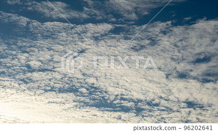 White clouds on a blue sky. Feather clouds in the sky, cloud background 96202641