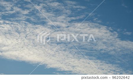 White clouds on a blue sky. Feather clouds in the sky, cloud background White clouds on a blue sky. Feather clouds in the sky, cloud background 96202642