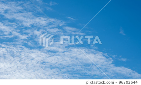 White clouds on a blue sky. Feather clouds in the sky, cloud background 96202644