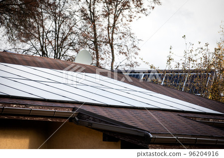 Solar panels on a shingle roof. Heating season, autumn and winter Solar panels on a shingle roof. Heating season, autumn and winter 96204916