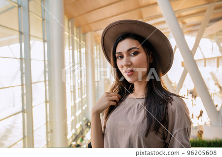 Girl at the airport window waits for a flight 96205608