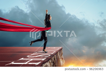Businesswoman thinks she has won but there is a precipe after the finishline Businesswoman thinks she has won but there is a precipe after the finishline 96206963