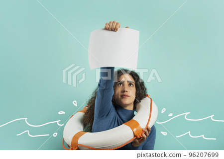 Woman is drowing and ask help with a message of a paper sheet. Cyan background Woman is drowing and ask help with a message of a paper sheet. Cyan background 96207699