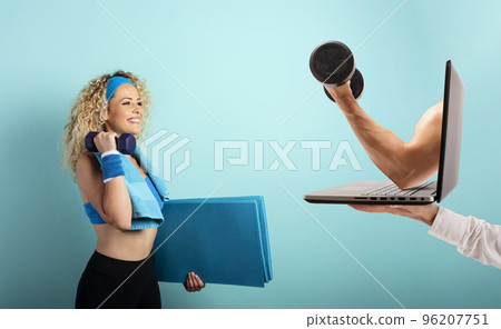 Girl with handlebars ready to start the gym online with a computer. cyan background 96207751
