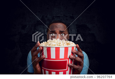 Worried boy watches a horror film. concept of entertainment and streaming tv. 96207764