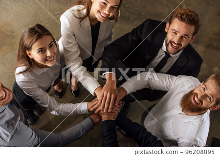 Business people putting their hands together. Concept of teamwork and partnership 96208095