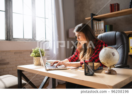 Girl teleworker works at home with a laptop. She is in smart working due to covid-19 pandemic 96208196