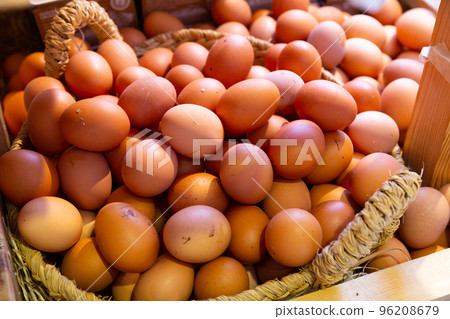 Raw fresh eggs in wicker basket at grocery store 96208679