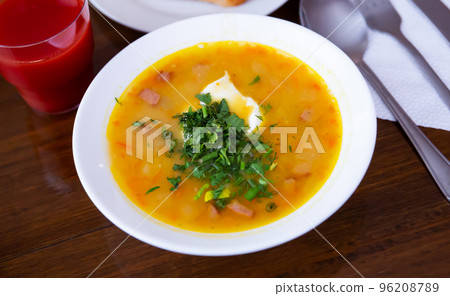 Plate of pea soup with smoked meats. 96208789
