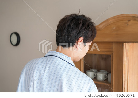 cupboard and man in pajamas 96209571