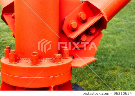 Bolted connection of metal support of mast or pillar close-up. Industrial wear-resistant all-weather paint for metal structures. Background. Bolted connection of metal support of mast or pillar close-up. Industrial wear-resistant all-weather paint for metal structures. Background. 96210634