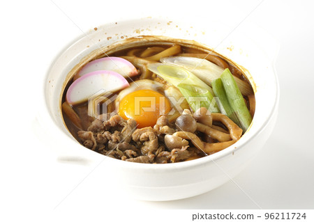 Miso-nikomi udon with beef, shimeji mushrooms, green onion, kamaboko, and egg yolk photographed against a white background Miso-nikomi udon with beef, shimeji mushrooms, green onion, kamaboko, and egg yolk photographed against a white background 96211724