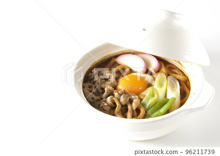 Miso-nikomi udon with beef, shimeji mushrooms, green onion, kamaboko, and egg yolk photographed against a white background Miso-nikomi udon with beef, shimeji mushrooms, green onion, kamaboko, and egg yolk photographed against a white background 96211739