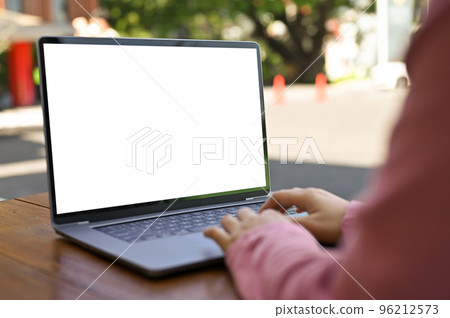 Asian female freelancer remote working at the cafe, using laptop. laptop white screen mockup. Asian female freelancer remote working at the cafe, using laptop. laptop white screen mockup. 96212573