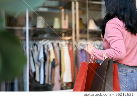 Asian woman with her shopping bags, shopping alone at the city square shopping center. Asian woman with her shopping bags, shopping alone at the city square shopping center. 96212621