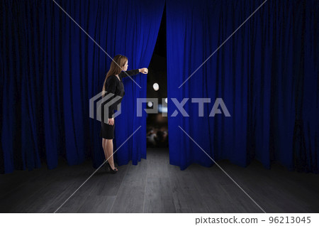 Woman open blue curtains of the theater stage 96213045